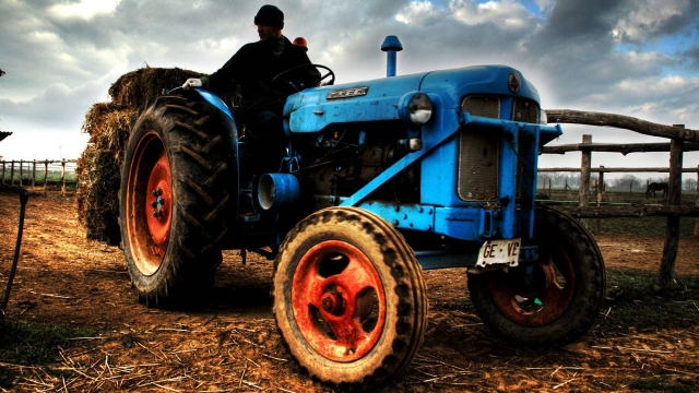 The Mighty Rides: Unleash the Power of the Holland Tractor!